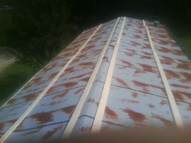 Rusted metal roof panels with new wood purlins before replacement — Storm Damage Roof Repair in Paoli by Roofing Brothers