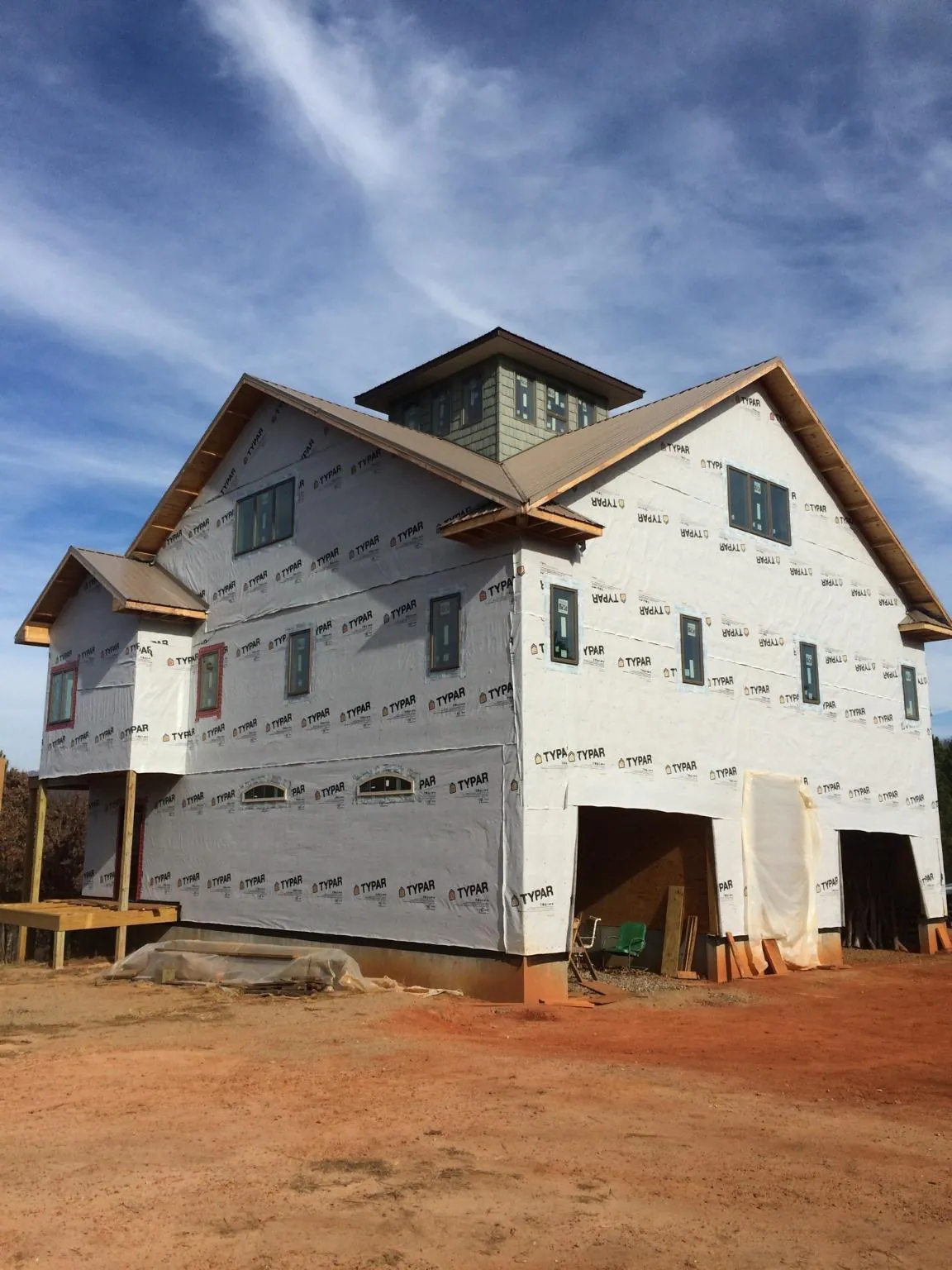New two story house under construction with a cupola and gabled roofs in Paoli